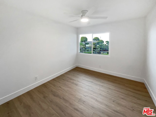 empty room featuring wood-type flooring and ceiling fan