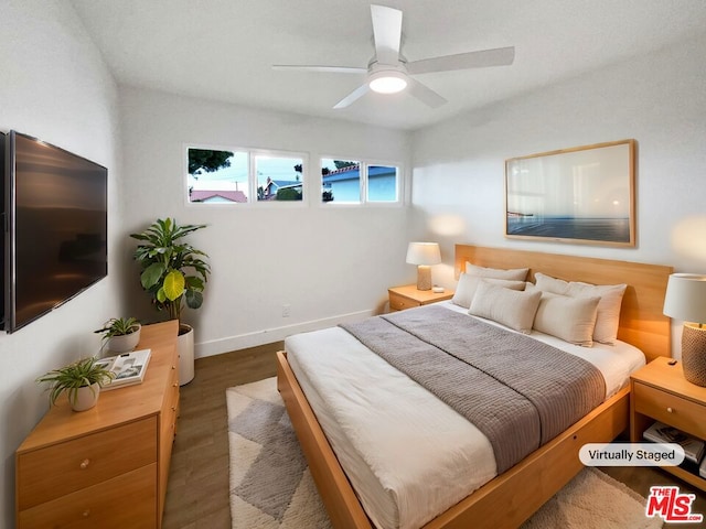 bedroom with dark wood-type flooring and ceiling fan