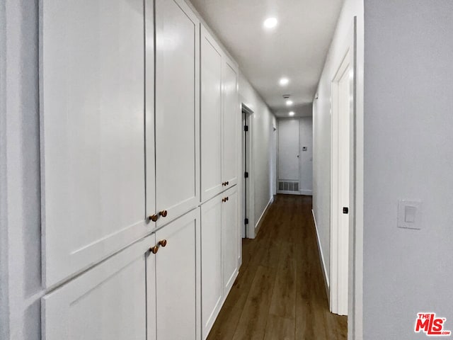 hallway with dark hardwood / wood-style floors