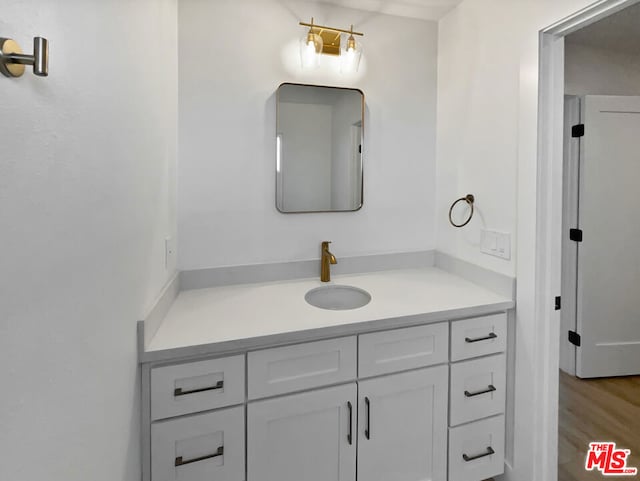 bathroom featuring vanity and hardwood / wood-style floors