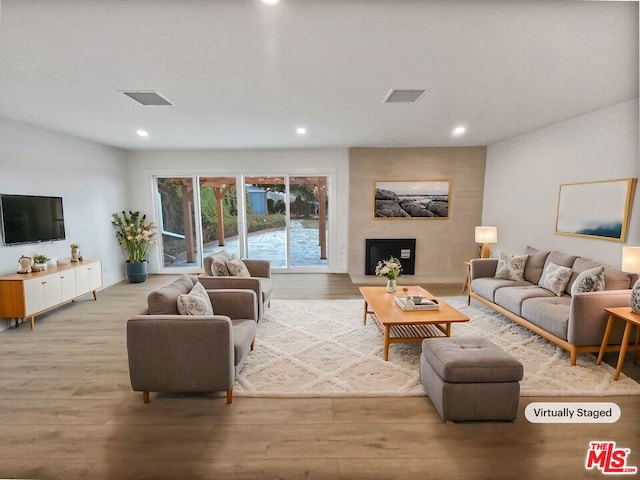 living room featuring a fireplace and light hardwood / wood-style floors