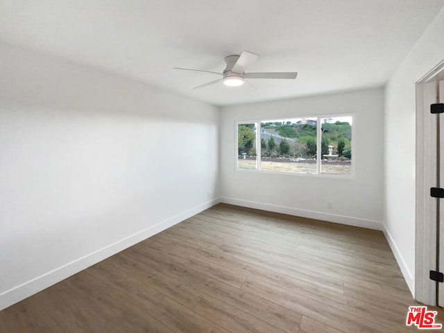 spare room featuring hardwood / wood-style flooring and ceiling fan