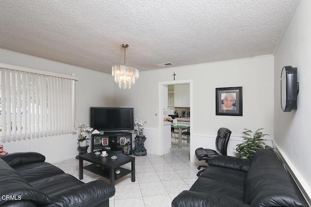 tiled living room with a notable chandelier and a textured ceiling