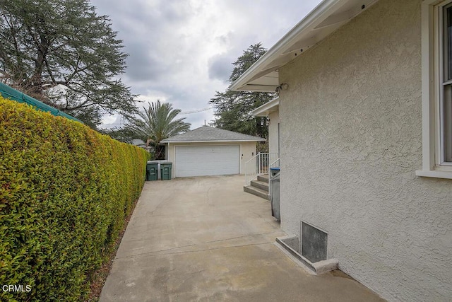 view of side of property with a garage and an outdoor structure