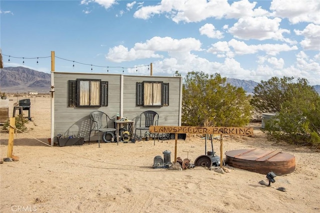 back of house with a mountain view