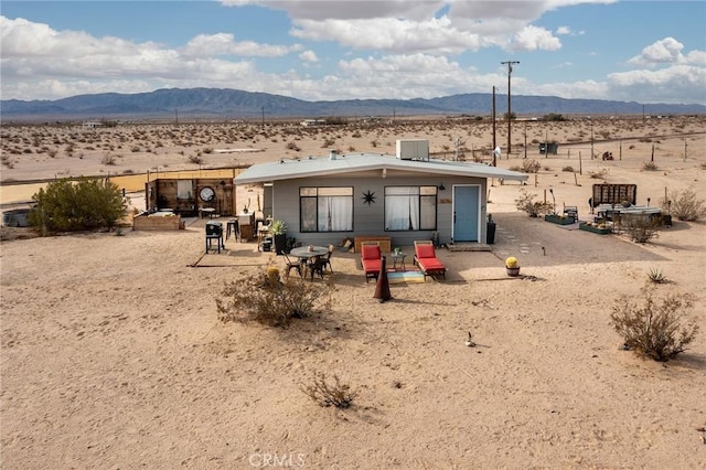 back of property with a mountain view