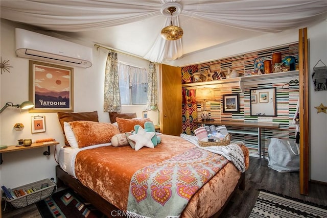 bedroom featuring hardwood / wood-style floors and a wall mounted air conditioner