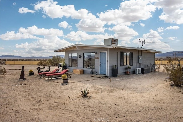 back of property with a mountain view