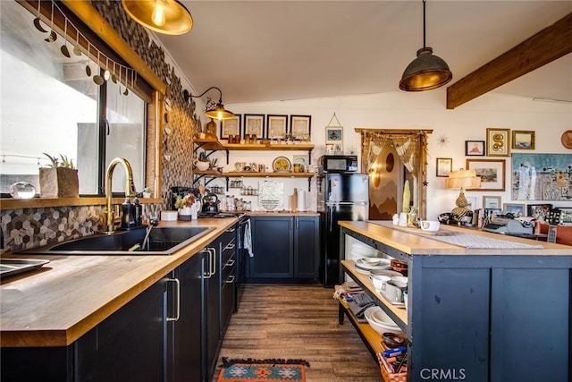 kitchen with sink, dark wood-type flooring, vaulted ceiling with beams, black appliances, and decorative light fixtures