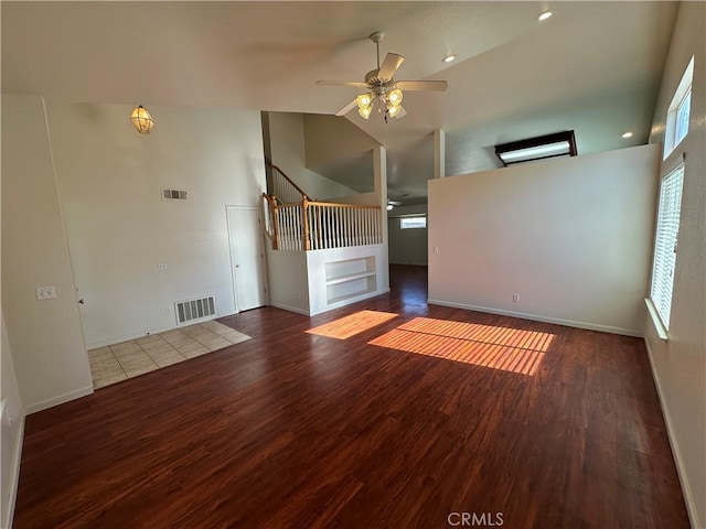 unfurnished room featuring ceiling fan, wood-type flooring, and high vaulted ceiling