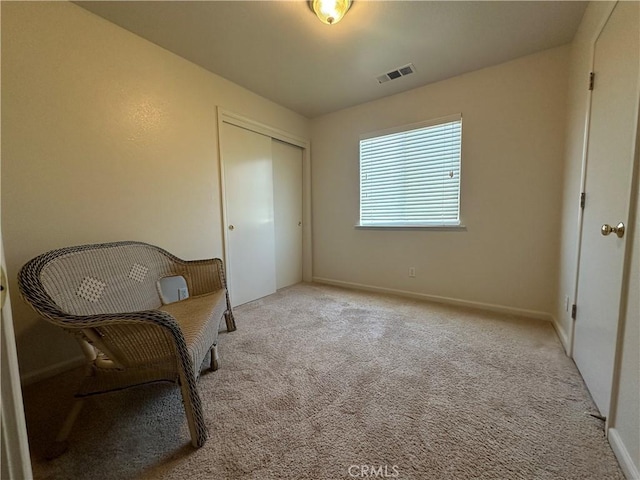 living area featuring light carpet