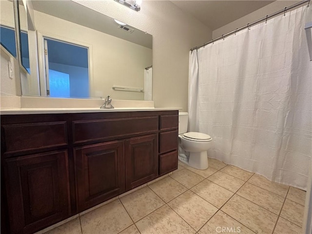 bathroom with tile patterned floors, toilet, and vanity