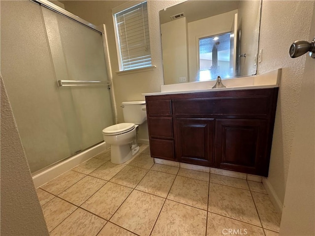 bathroom featuring vanity, toilet, tile patterned floors, and walk in shower