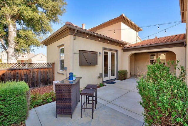 back of house featuring a patio area and french doors