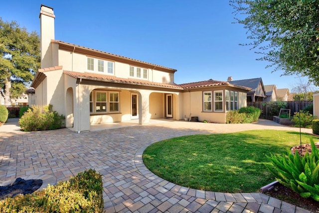 back of house with a yard and a patio area