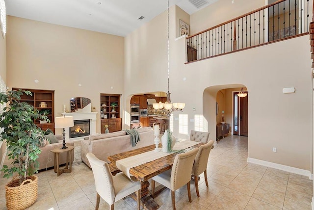 dining room with light tile patterned floors and an inviting chandelier