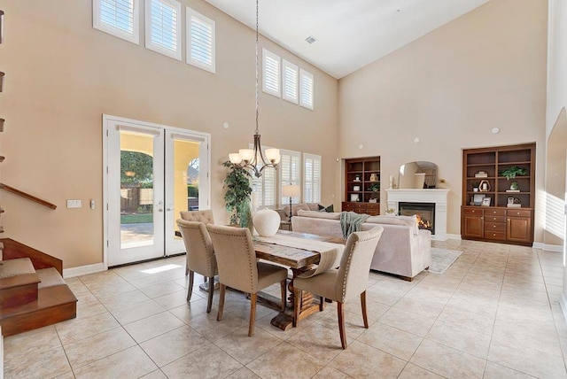 dining space with light tile patterned floors, an inviting chandelier, and french doors