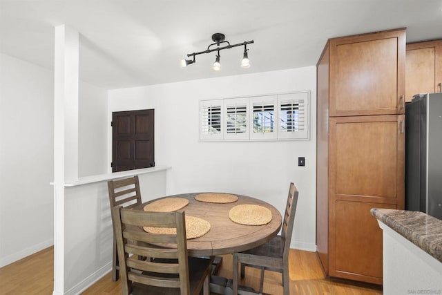 dining space with light wood-type flooring