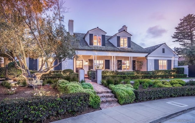 cape cod-style house with a porch