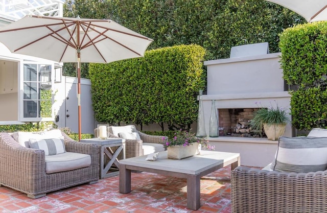 view of patio / terrace featuring an outdoor living space with a fireplace