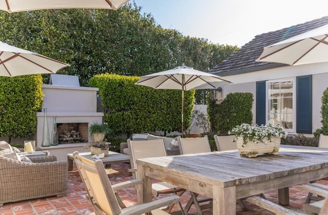 view of patio with exterior fireplace