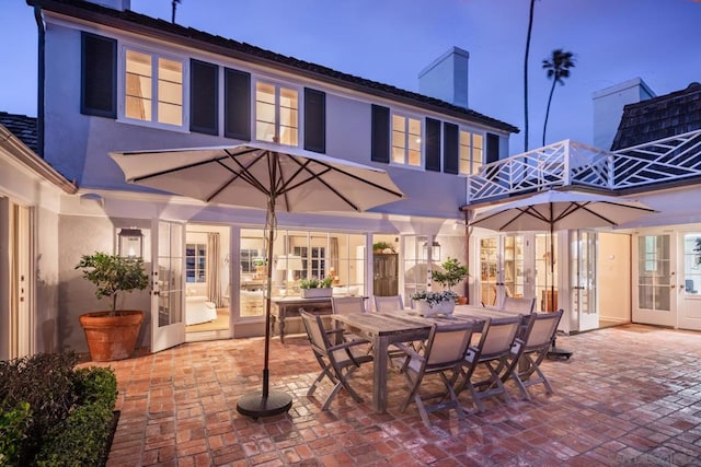 patio terrace at dusk featuring french doors