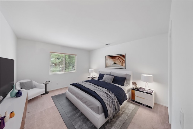 bedroom featuring light carpet