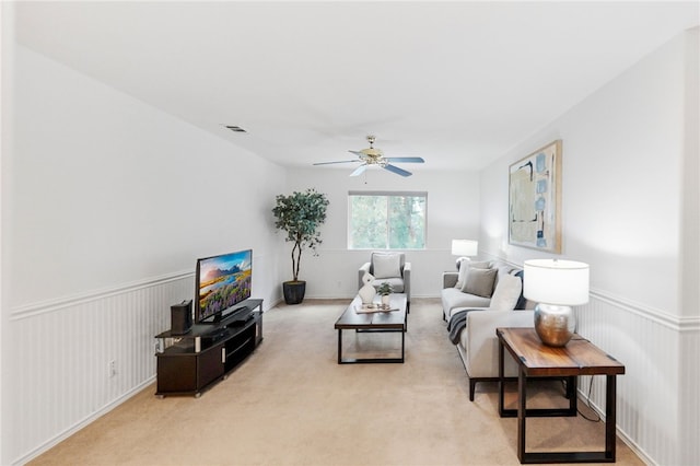 carpeted living room featuring ceiling fan