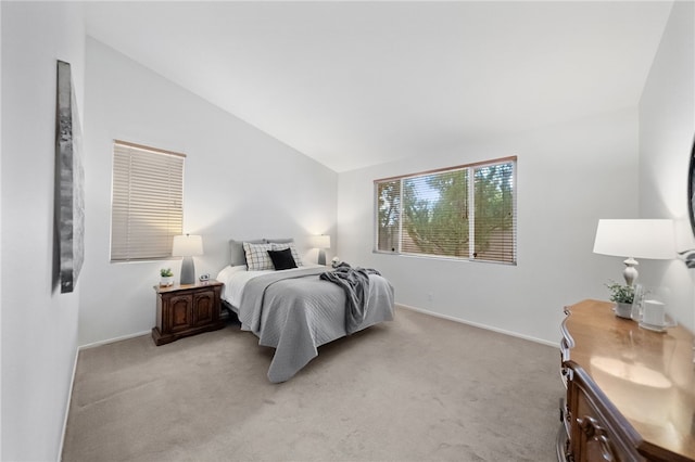 bedroom with light carpet and vaulted ceiling