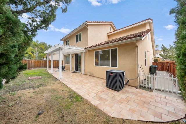 rear view of property with a yard, a pergola, a patio area, and central air condition unit