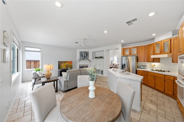 dining space featuring built in shelves and ceiling fan