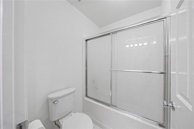 bathroom featuring lofted ceiling, enclosed tub / shower combo, and toilet