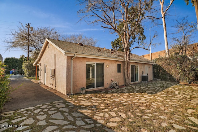 back of property featuring central AC