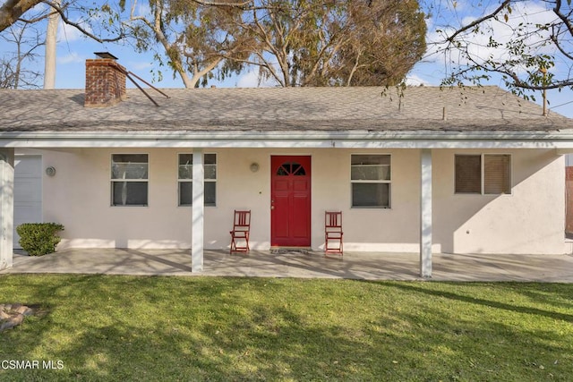 rear view of house with a yard and a patio area