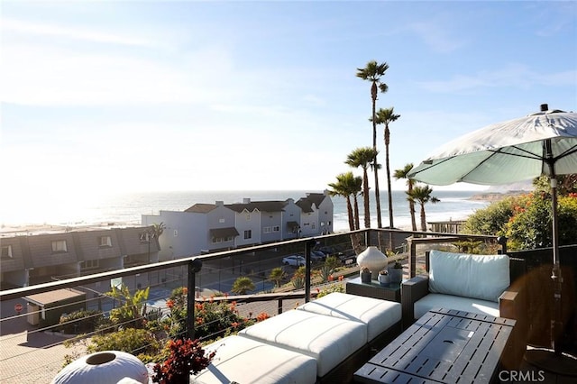 balcony featuring an outdoor hangout area and a water view