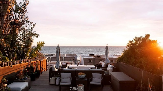 wooden terrace featuring a water view