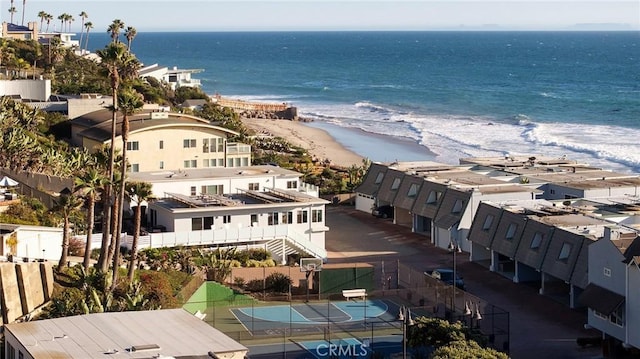 drone / aerial view featuring a water view and a view of the beach