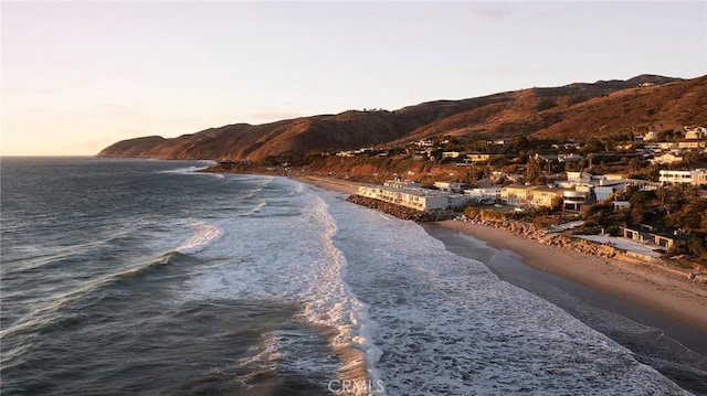 view of water feature featuring a mountain view and a beach view