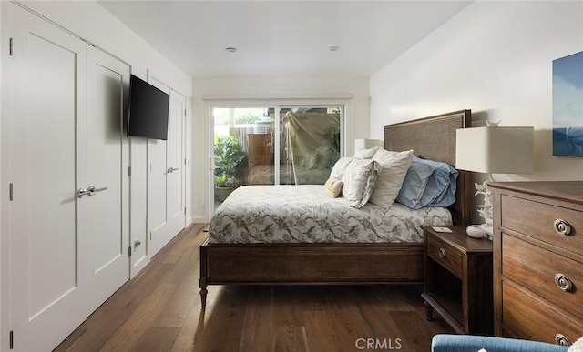 bedroom with access to exterior and dark hardwood / wood-style flooring