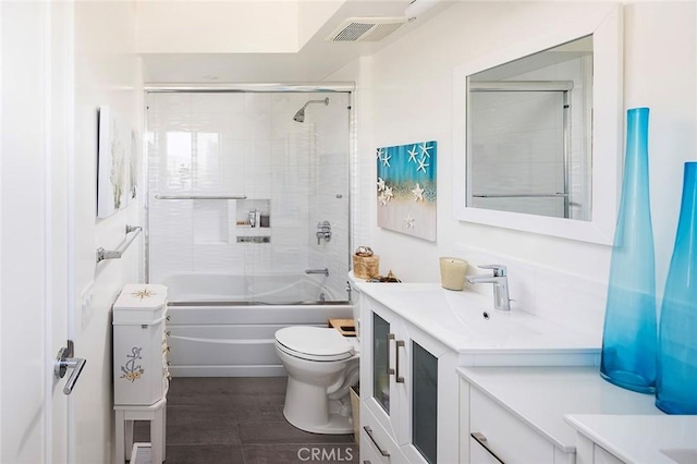 full bathroom featuring vanity, toilet, and combined bath / shower with glass door