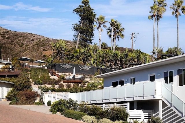 exterior space with a balcony and a mountain view