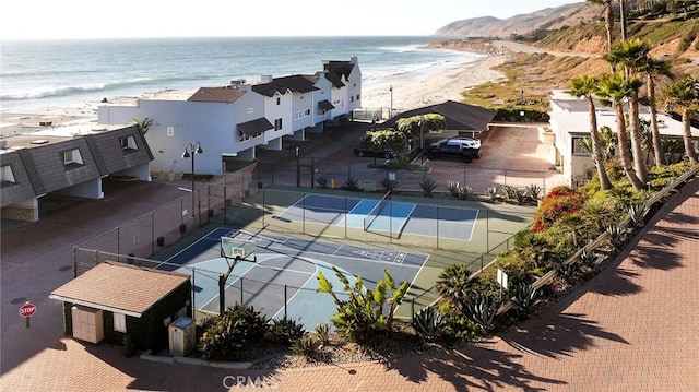 birds eye view of property featuring a water view and a beach view