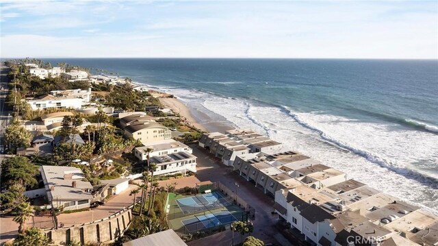 drone / aerial view featuring a water view and a view of the beach