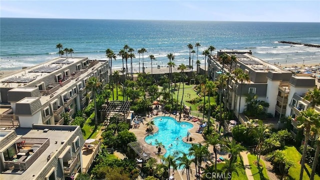 birds eye view of property featuring a water view and a beach view