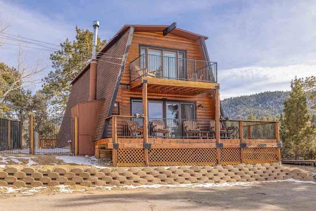 view of front of home featuring a balcony and a deck