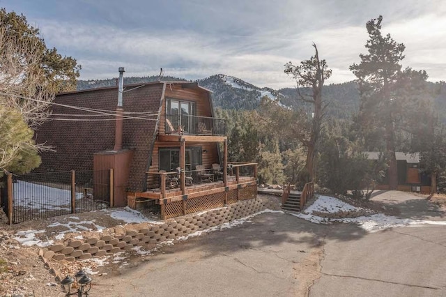 exterior space with a balcony and a mountain view