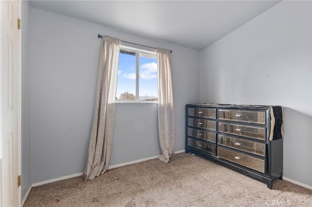 bedroom featuring light colored carpet and lofted ceiling