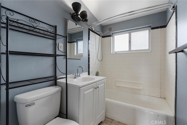 full bathroom with vanity, tiled shower / bath, tile patterned floors, and toilet