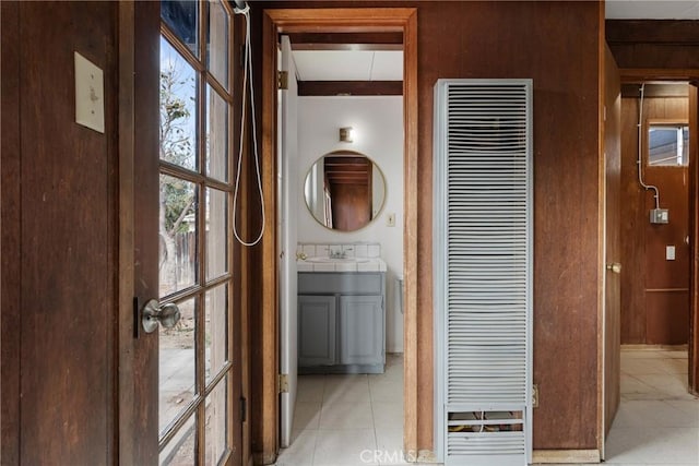 hallway featuring sink and light tile patterned floors