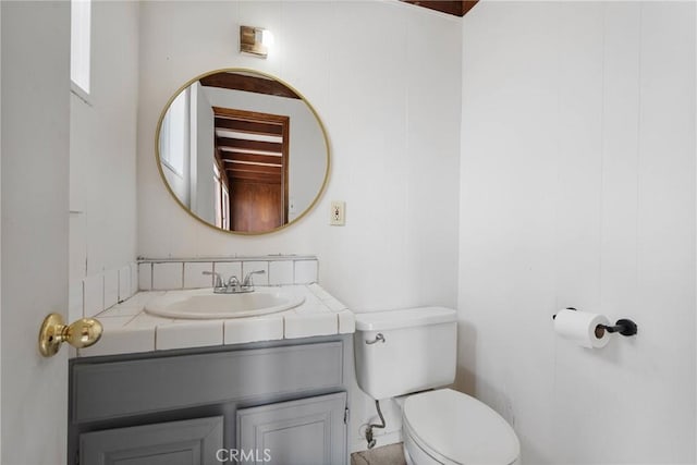 bathroom featuring vanity and toilet